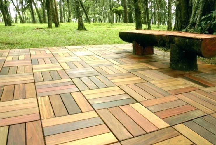 composite interlocking patio tiles on grass in the backyard