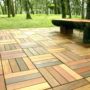 composite interlocking patio tiles on grass in the backyard