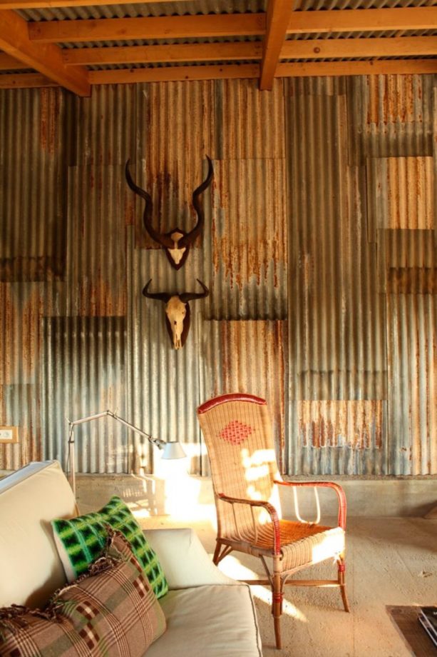 a rustic living room wall covered by reclaimed corrugated metal panels