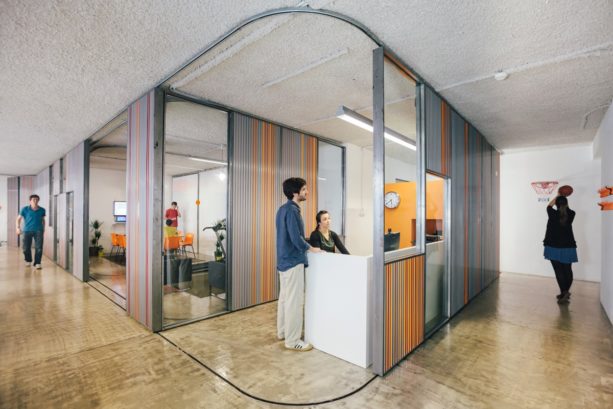 corrugated metal garage doors used to create flexible moveable office walls