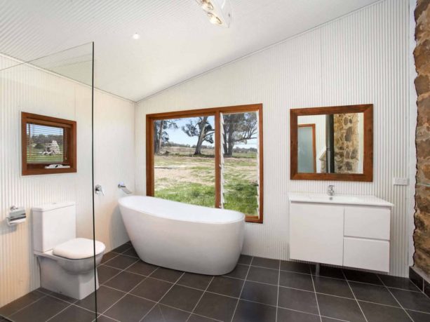white corrugated metal walls in an industrial bathroom