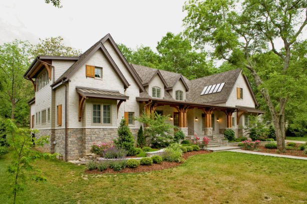 a tan brick house with wood-color shutters