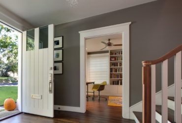 a traditional entry with white trim that seems to frame the dark wood floor
