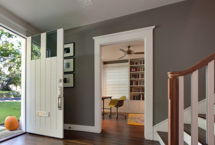 a traditional entry with white trim that seems to frame the dark wood floor