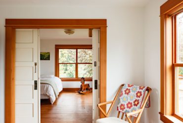 white sliding doors paired with an orangish wood trim