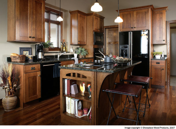 a traditional kitchen with glazed white oak, black appliances, and off-white wall paint