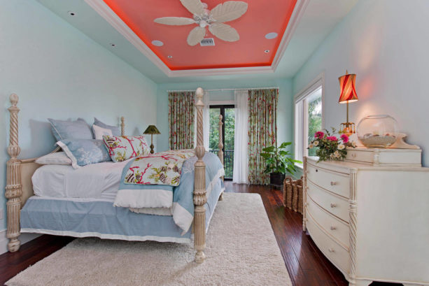 a tropical bedroom with coral, light blue, and off-white tones