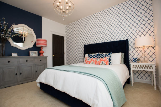 navy blue, coral, and grey accentsin a modern bedroom