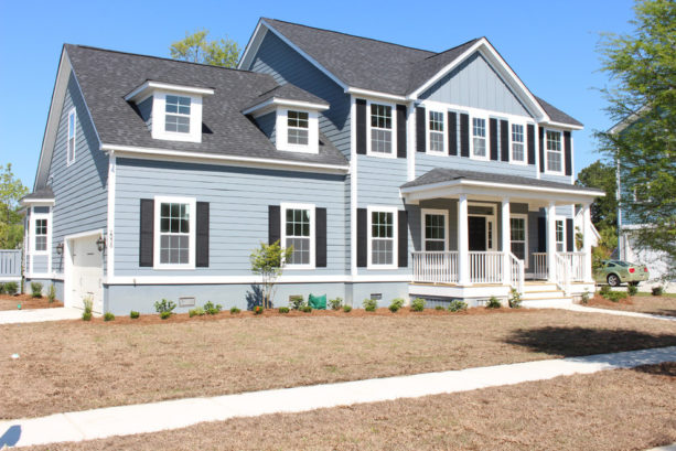 a light blue house with white trim and black shutters