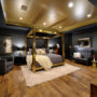 a luxurious eclectic bedroom with black, gold, and grey colors