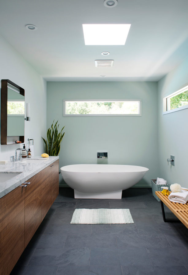 a mid-century modern bathroom with grey slate floor