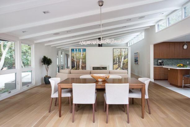 a mid-century modern dining room with clear-sealed maple floor