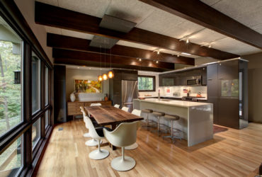 a mid-century modern kitchen dining with clear-coated quartered oak floor