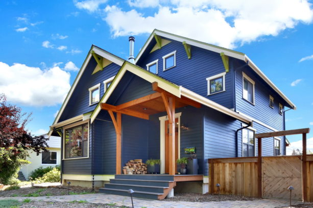 a navy blue craftsman house with white trim