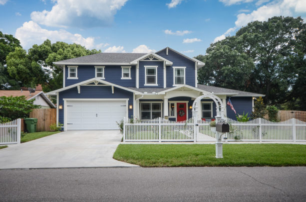 a navy blue house with white trim and red door