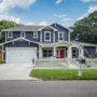 a navy blue house with white trim and red door