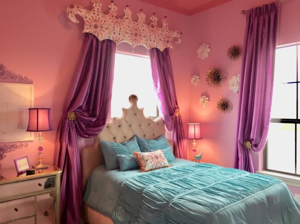a princess bedroom with pink walls, purple curtains, and blue bedding