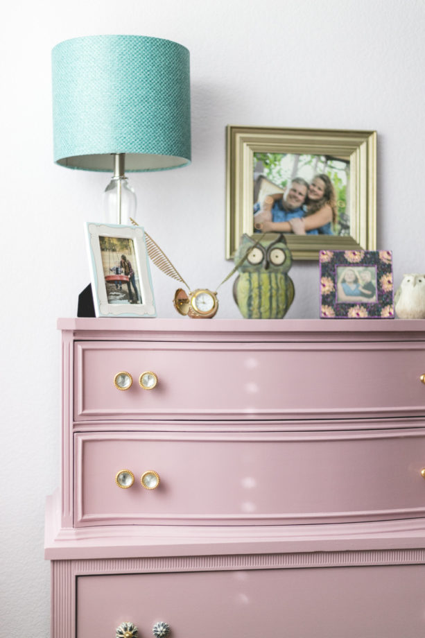 the pink dresser in the corner of the pink and mauve shabby chic bedroom
