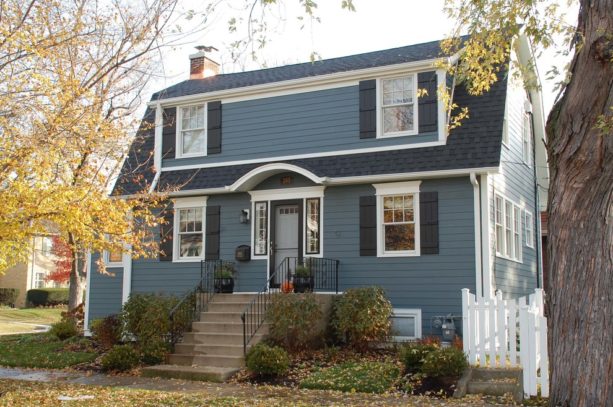 traditional blue house with white trim and black shutters