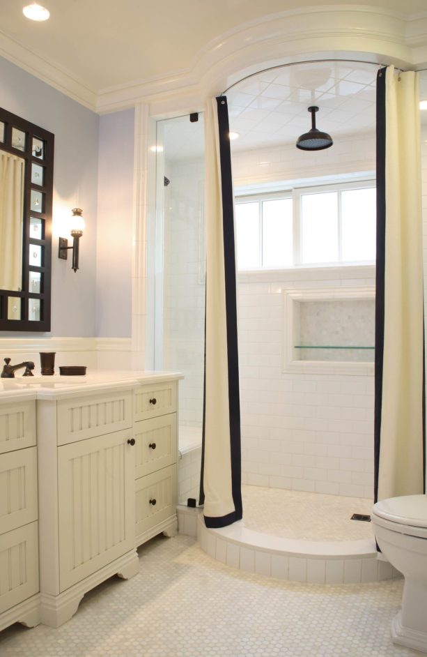 a shower room with white subway tile and snow white grout