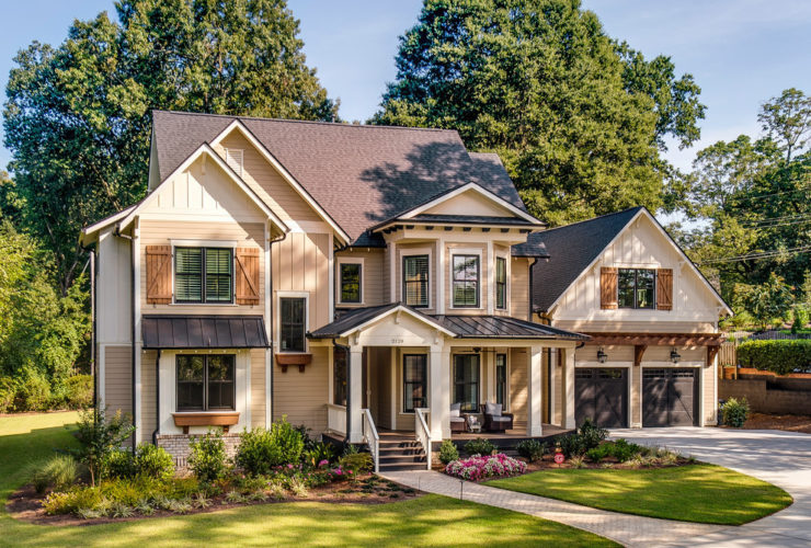 a traditional beige and eggnog tan house with brown roof