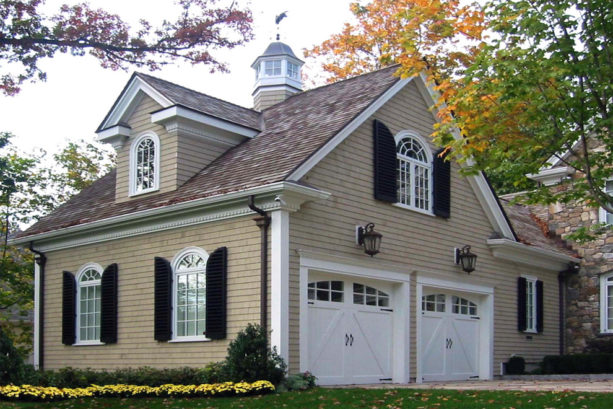 home exterior with tan wall siding and black shutters