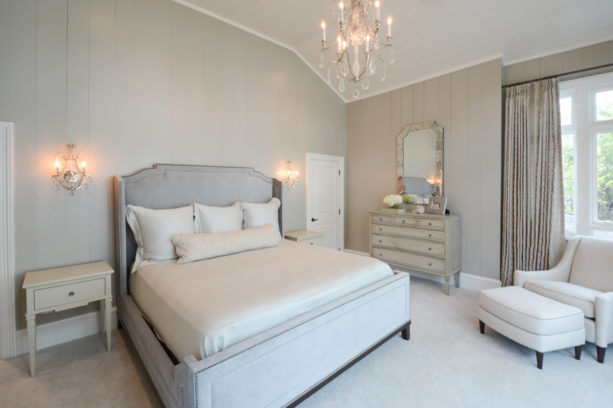 a transitional bedroom with white carpet flooring and light grey walls