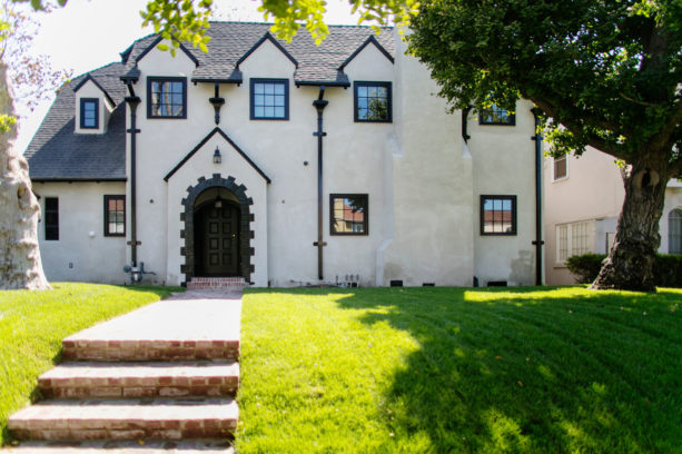 black gutters decorating the exterior of a white house with black trim detailing