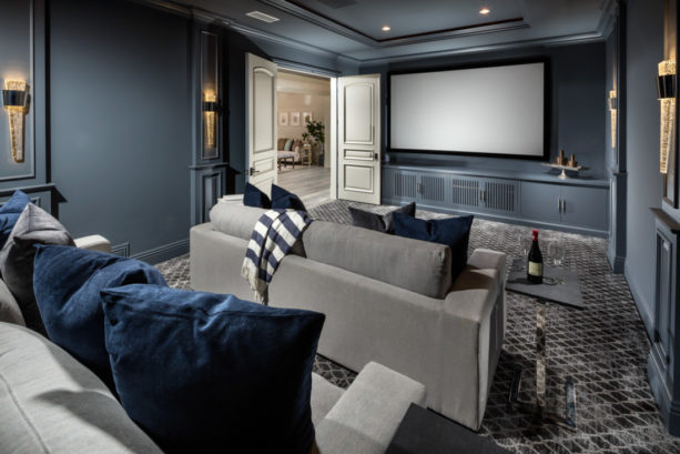 white-patterned grey carpet floor in a home theater with dark grey walls