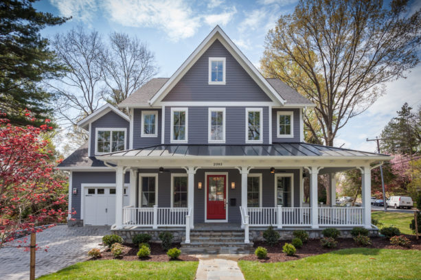 a traditional grey house with red door and white trim