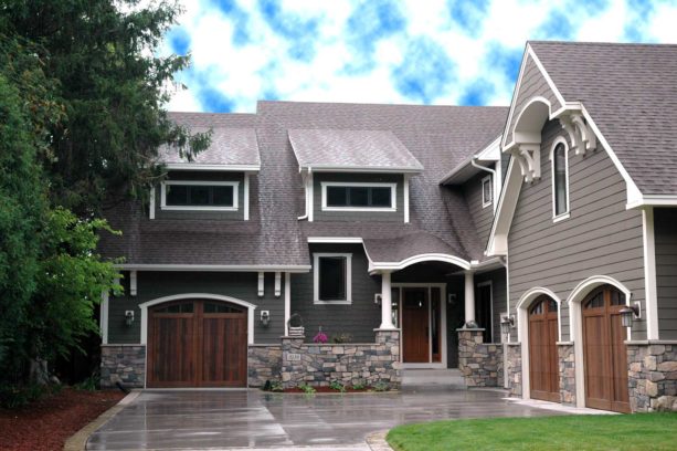 a traditional house with white trim and cozy wood accents from the doors
