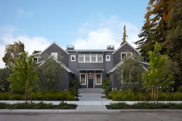 a transitional home exterior with dark gray siding and white trim
