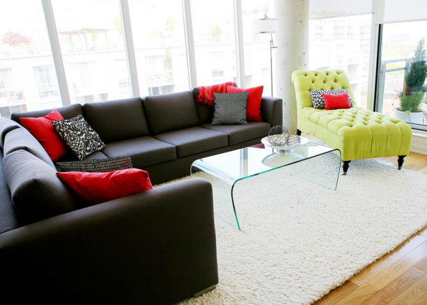 the pairing of charcoal grey, bright red, and yellow colors for a contrast living room visual