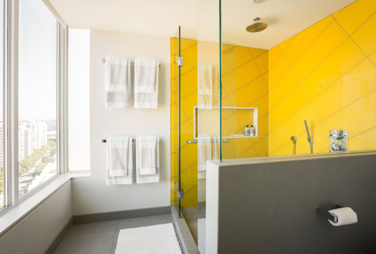 yellow shower room in a modern grey bathroom