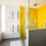 yellow shower room in a modern grey bathroom