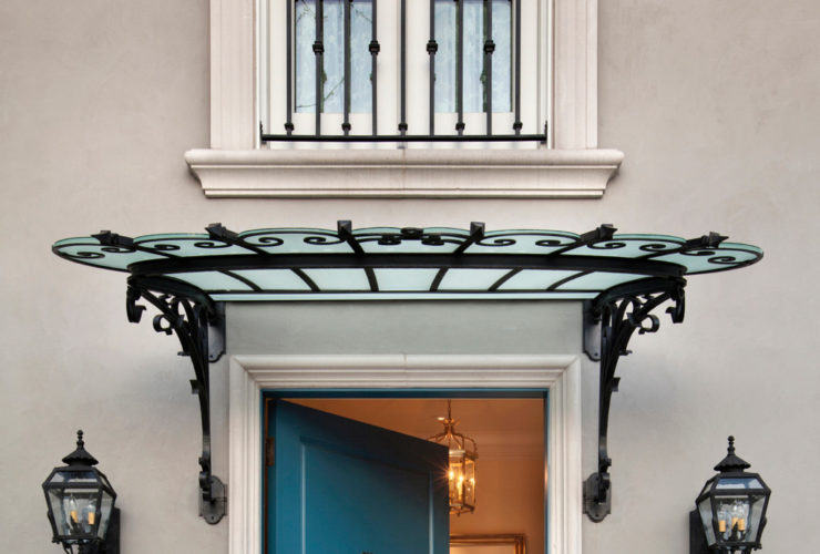a blue front door with mitered casing in a traditional home exterior design