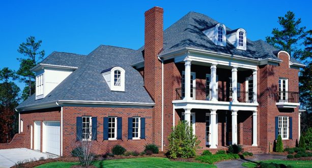 a red brick exterior with dark blue shutters