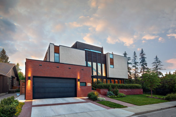a safe combination of red brick garage and black door