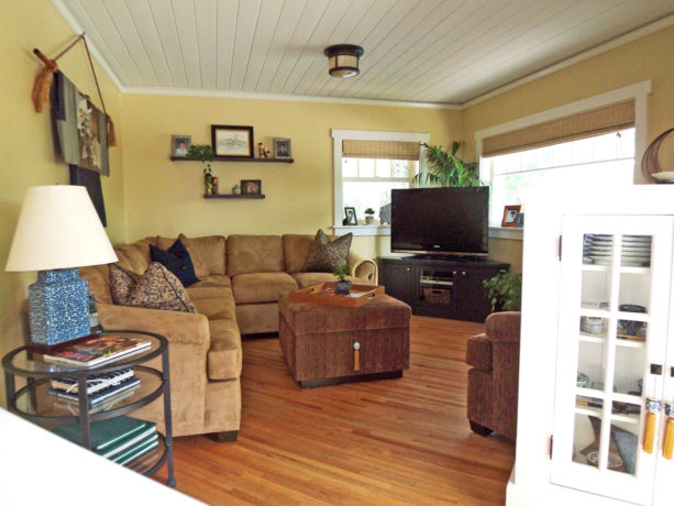 Asian-inspired family room with natural-looking roman blinds covering the windows with a TV in front of them