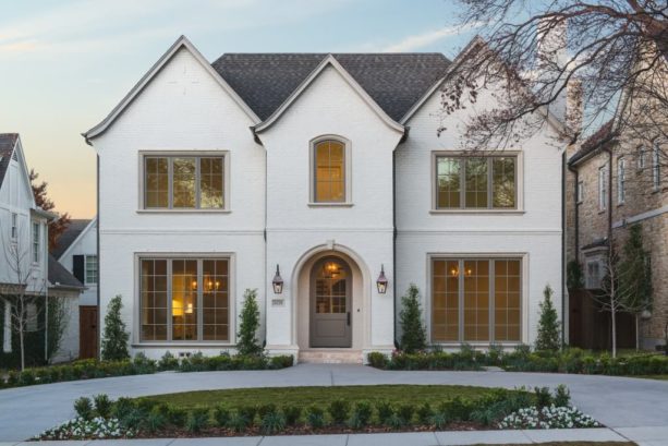 white brick exterior paired with warm grey front door