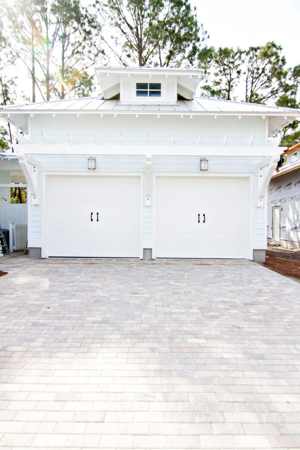 huge beach style detached two-car carport in front of a crisply white garage