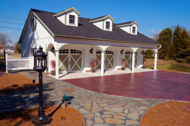 large three-car carport in front of a farmhouse garage