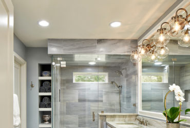 modern master bathroom without tub featuring a long vanity and quartzite countertops