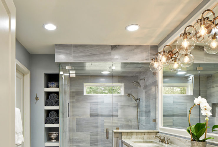 modern master bathroom without tub featuring a long vanity and quartzite countertops