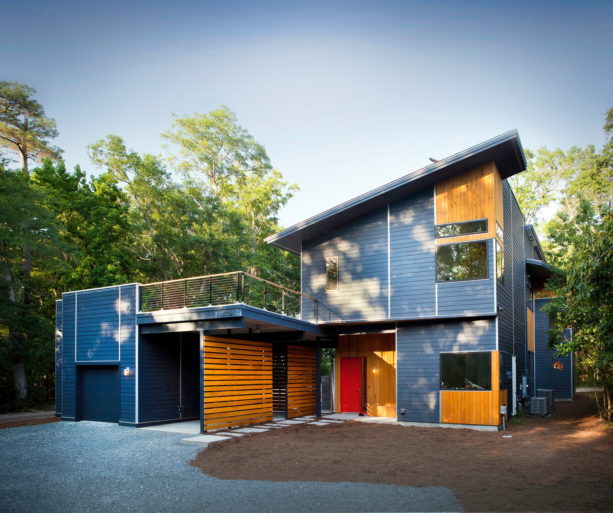 roof deck over semi-attached carport in front of a sophisticated garage