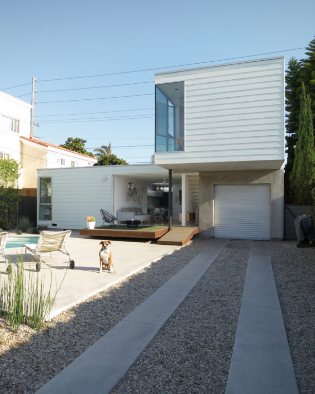 tiny yet chic carport idea with pathway in front of a metal railing door garage