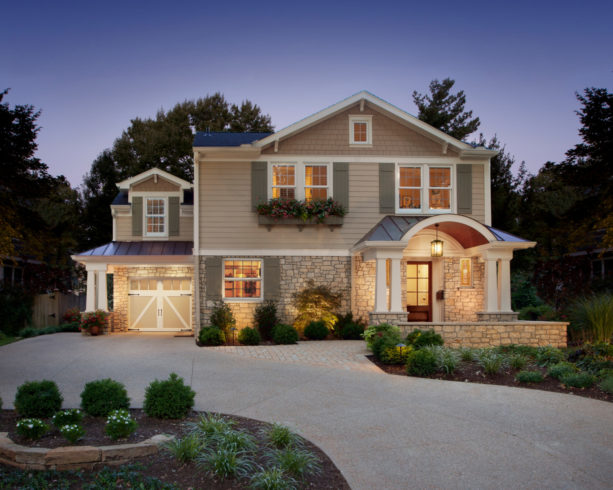 transitional garage with double side-hinged door and stone paved carport at the front