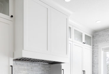 u-shaped shaker white cabinets and black granite countertops in a contemporary kitchen