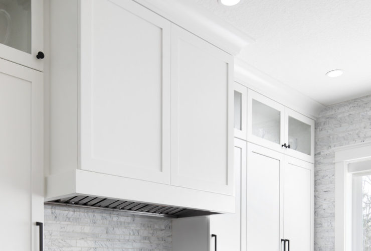 u-shaped shaker white cabinets and black granite countertops in a contemporary kitchen