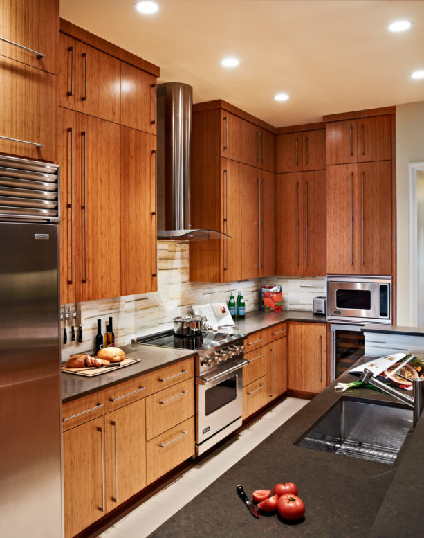 caramelized bamboo floor to ceiling cabinets with stainless steel appliances